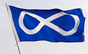 The Métis flag, a blue flag with a white infinity symbol representing the continuity of Métis culture and people.
